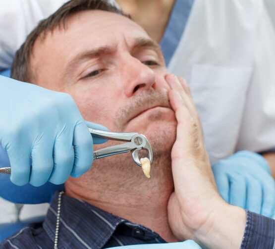 Dentist remove the bad tooth with the pliers from the patient